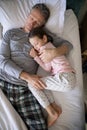 Father and daughter sleeping together on bed in bedroom Royalty Free Stock Photo