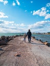 Father and daughter smiling walking running on empty beach. Lifestyle photo real people. Happy active family having fun Royalty Free Stock Photo