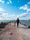 Father and daughter smiling walking running on empty beach. Lifestyle photo real people. Happy active family having fun Royalty Free Stock Photo