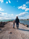 Father and daughter smiling walking running on empty beach. Lifestyle photo real people. Happy active family having fun Royalty Free Stock Photo