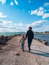 Father and daughter smiling walking running on empty beach. Lifestyle photo real people. Happy active family having fun Royalty Free Stock Photo