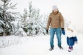 Father and daughter at snowy park.