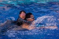 Father and daughter swim together with happily