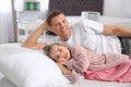 Father and daughter testing mattress