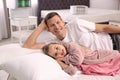 Father and daughter testing mattress