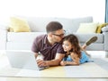 child father daughter laptop family gir computer parent together technology home kiss lying down Royalty Free Stock Photo