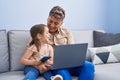 Father and daughter father and daughter using laptop and smartphone at home Royalty Free Stock Photo
