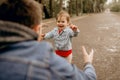 Father and daughter walk in the rain in the park, the emotions of the child, wet clothes Royalty Free Stock Photo