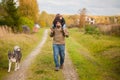 Father and daughter walking together with dog, autumn day. Royalty Free Stock Photo