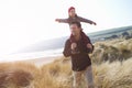 Father And Daughter Walking Through Dunes On Winter Beach Royalty Free Stock Photo