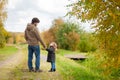 Father and daughter walking together, autumn day. Royalty Free Stock Photo