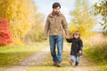 Father and daughter walking together, autumn day. Royalty Free Stock Photo