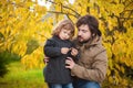 Father and daughter walking together, autumn day. Royalty Free Stock Photo