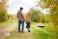 Father and daughter walking together, autumn day. Royalty Free Stock Photo
