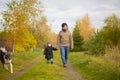 Father and daughter walking together with dog, autumn day. Royalty Free Stock Photo