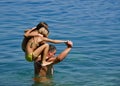 Father with daughters in fun on sea Royalty Free Stock Photo