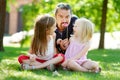 Father and daughters playing with paper moustaches on a stick Royalty Free Stock Photo