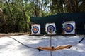 Father and daughters practicing archery together Royalty Free Stock Photo