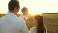 Father with daughters resting in the park. concept of happy family and childhood. The family plays with the baby at