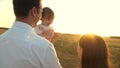 Father with daughters resting in the park. concept of happy family and childhood. The family plays with the baby at