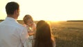 Father with daughters resting in the park. concept of happy family and childhood. The family plays with the baby at