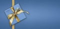 Father day blank gift greeting card with gift box present and bright shiny golden ribbon bow tape isolated on blue background, top Royalty Free Stock Photo