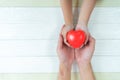 Father Day`s and Mother`s Day. Man holds his hands son supporting red heart Royalty Free Stock Photo