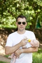 Father drinking milk his bottle baby boy