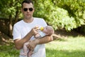 Father drinking milk his bottle baby boy