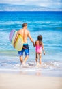 Father and Duagher on the Beach Going Surfing Royalty Free Stock Photo