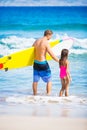 Father and Duagher on the Beach Going Surfing Royalty Free Stock Photo