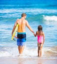 Father and Duagher on the Beach Going Surfing Royalty Free Stock Photo