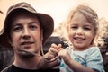Father embracing beautiful smiling kid daughter portrait vintage style sunlight concept happy parenting lifestyle