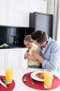 father embracing cheerful daughter near orange Royalty Free Stock Photo