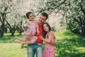 Father enjoying spring walk with two kid daughters. Family with two sisters