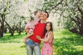 Father enjoying spring walk with two smiling kid daughters