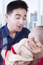 Father entertain his baby in the apartment Royalty Free Stock Photo