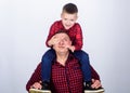 Father example of noble human. Best friends forever. Father little son red shirts family look outfit. Dad piggybacking Royalty Free Stock Photo