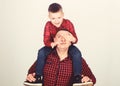 Father example of noble human. Best friends forever. Father little son red shirts family look outfit. Dad piggybacking Royalty Free Stock Photo