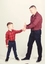 Father example of noble human. Cool guys. Father little son red shirts family look outfit. Best friends forever Royalty Free Stock Photo