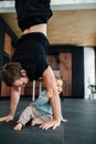 Father exercising, stadning on his hands next to his infant baby Royalty Free Stock Photo