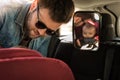 Father fasten his baby in car seat Royalty Free Stock Photo