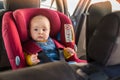 Father fasten his baby in car seat Royalty Free Stock Photo