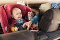 Father fasten his baby in car seat Royalty Free Stock Photo