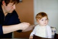 Father feeding baby girl from spoon mashed vegetables and puree. food, child, feeding and people concept -cute toddler Royalty Free Stock Photo