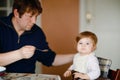 Father feeding baby girl from spoon mashed vegetables and puree. food, child, feeding and people concept -cute toddler, daughter Royalty Free Stock Photo