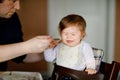 Father feeding baby girl from spoon mashed vegetables and puree. food, child, feeding and people concept -cute toddler Royalty Free Stock Photo