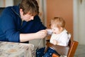 Father feeding baby girl from spoon mashed vegetables and puree. food, child, feeding and people concept -cute toddler Royalty Free Stock Photo