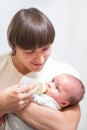 Father feeding his baby infant from bottle Royalty Free Stock Photo