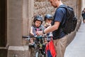 Father feeding his little son on a bicycle